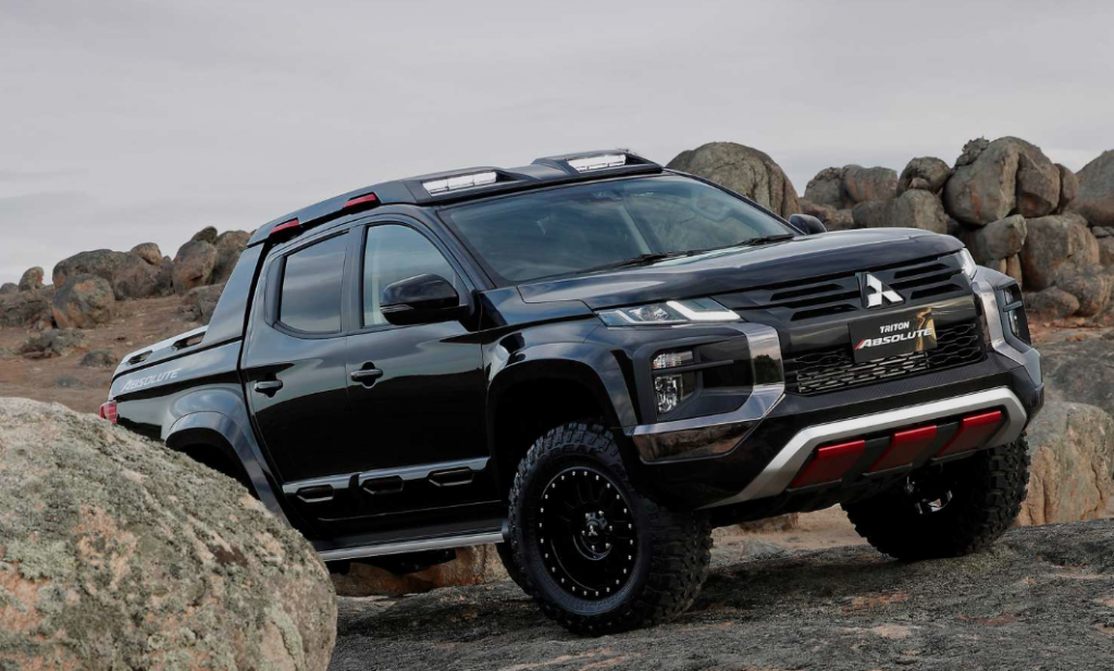 2020 Mitsubishi Triton-00 pickup truck off-road on rocky terrain is a model not sold in the U.S.