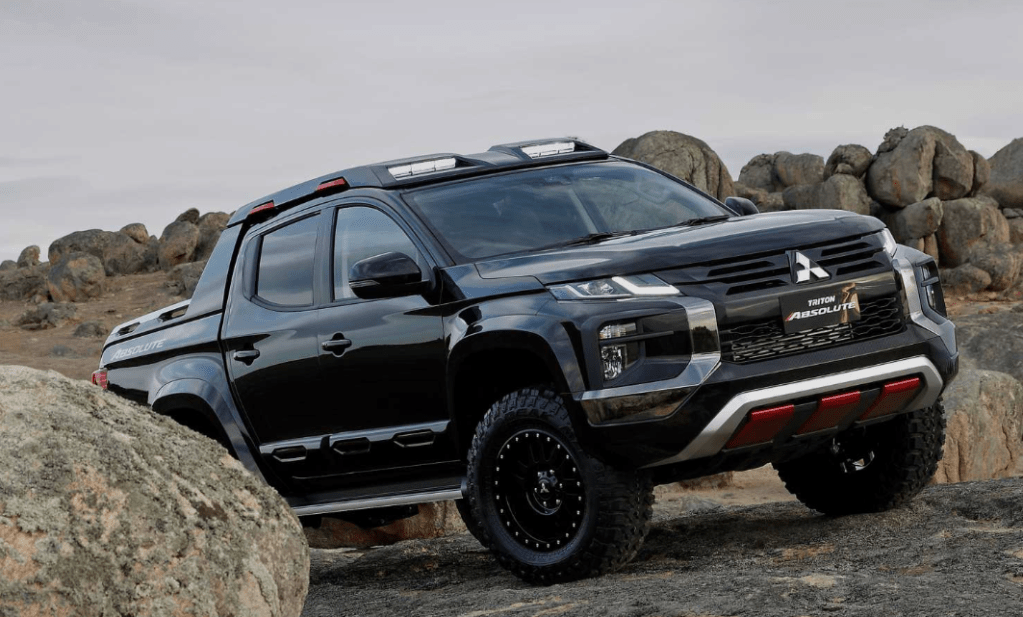 2020 Mitsubishi Triton-00 pickup truck off-road on rocky terrain is a model not sold in the U.S.
