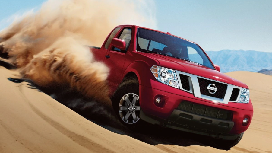 A red Nissan Frontier sanding.