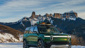 a green electric SUV in the snow