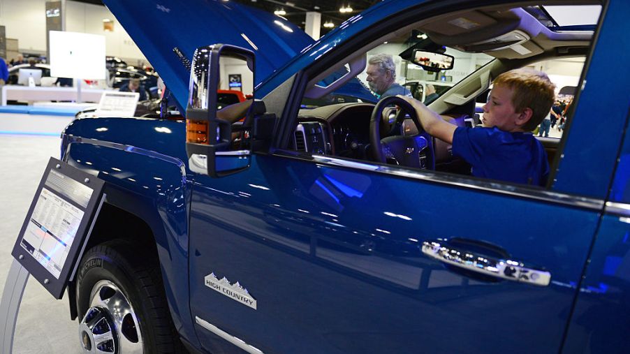 Joshua Santos, 10 of Loveland, checks out a 2015 Chevy Silverado 3500 High Country 4WD