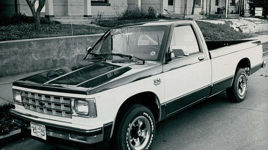 A black and white photo of a Chevy S10 parked on the street.