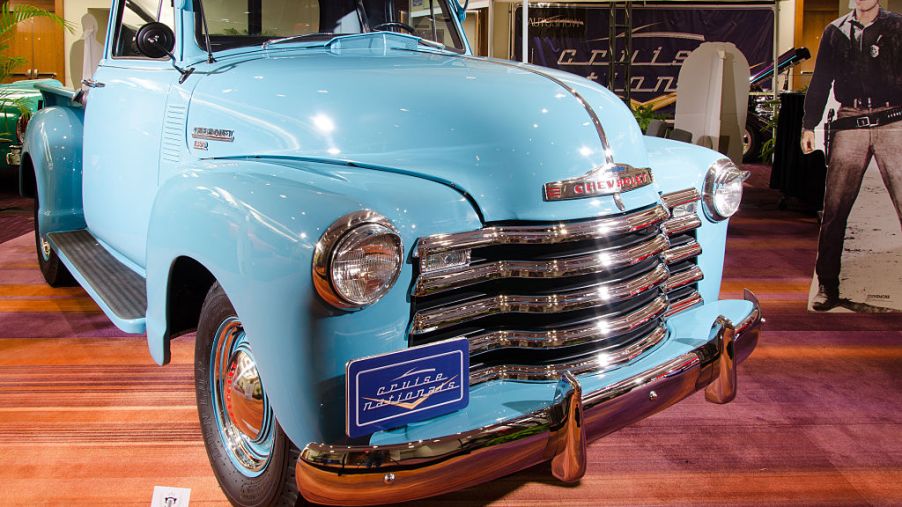 A light blue restored classic Chevy pickup truck on display.
