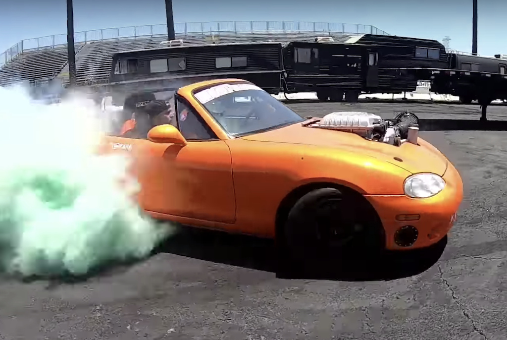A Hellcat/Mazda Miata mashup car races away