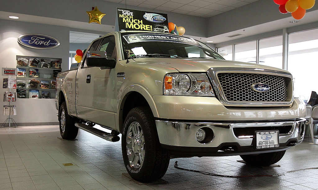 A Ford F-150 truck in the showroom of a car dealer.