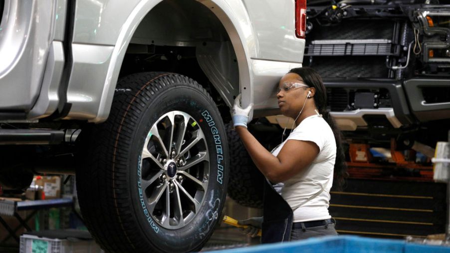 A Ford Motor Company worker works on a Ford F-150 truck on the assembly line at the automaker's Dearborn Truck Plant