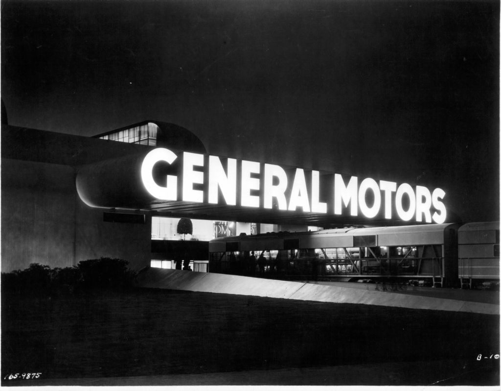 An illuminated GM sign on a building.
