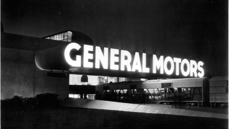 An illuminated GM sign on a building.