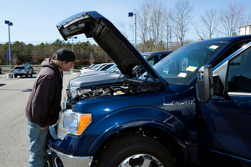 A customer looks at a Ford Motor Co. F-150 pickup truck at a CarMax Inc. dealership in Brandywine, Maryland, U.S., on Sunday, March. 29, 2015. Photographer: Hasan Sarbakhshian/Bloomberg via Getty Images