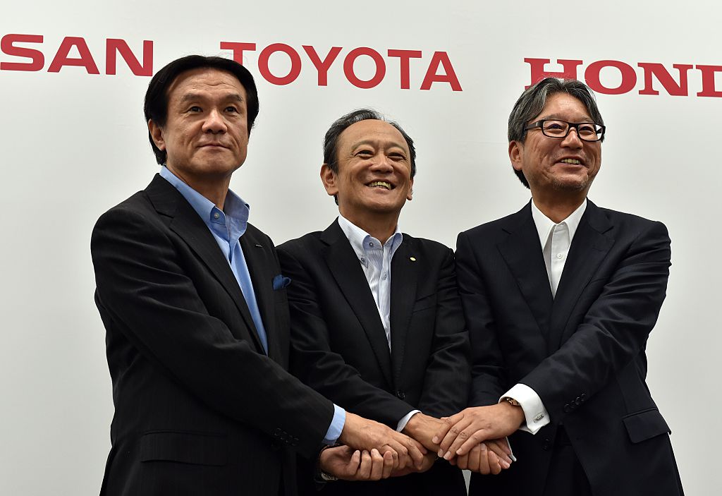 Leaders from all three Japanese truck makers posing for a photo.