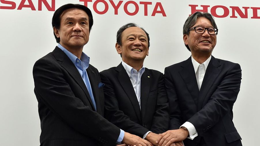 Leaders from all three Japanese truck makers posing for a photo.