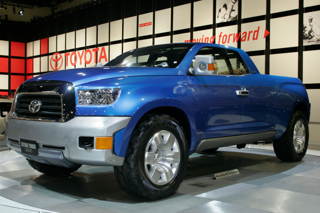 A blue hybrid Toyota pickup truck on display