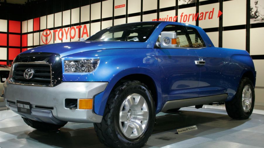 A blue hybrid Toyota pickup truck on display