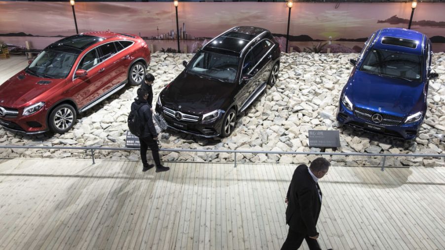 The Mercedes-Benz GLE Coupe, GLC L SUV, and GLC Coupe sit on display at an event ahead of the Shanghai Auto Show