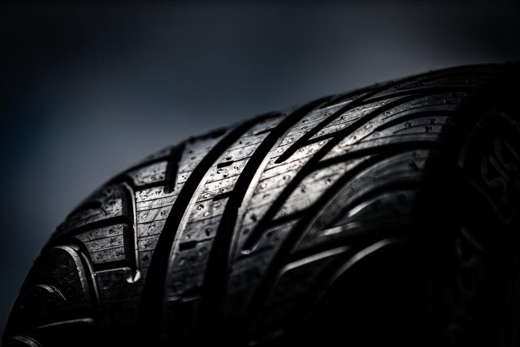 A wet car tire closeup