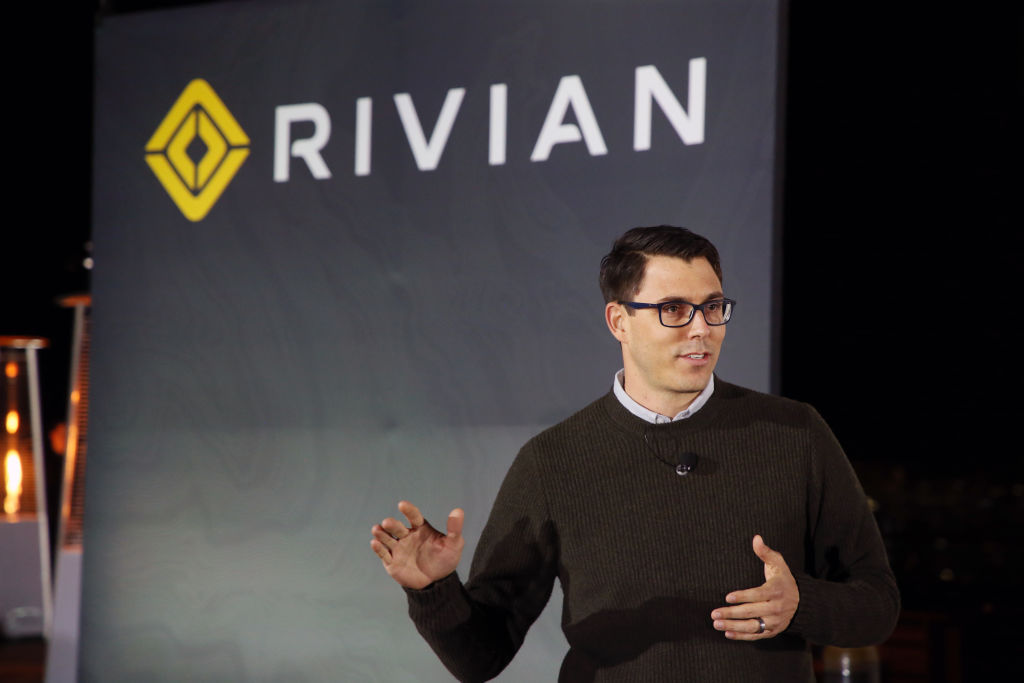 Rivian's CEO talking about a new truck at an auto show.