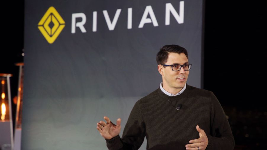 Rivian's CEO talking about a new truck at an auto show.