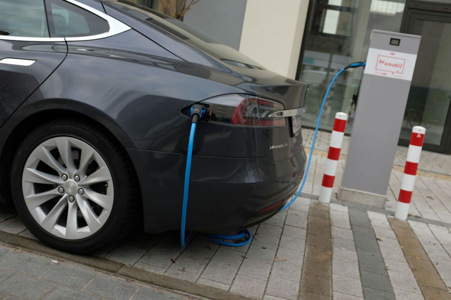 A Tesla Model S electric car parked at a charging station.