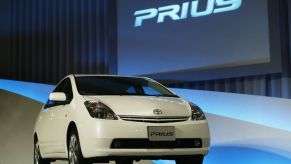 A white Toyota Prius on display at an auto show.