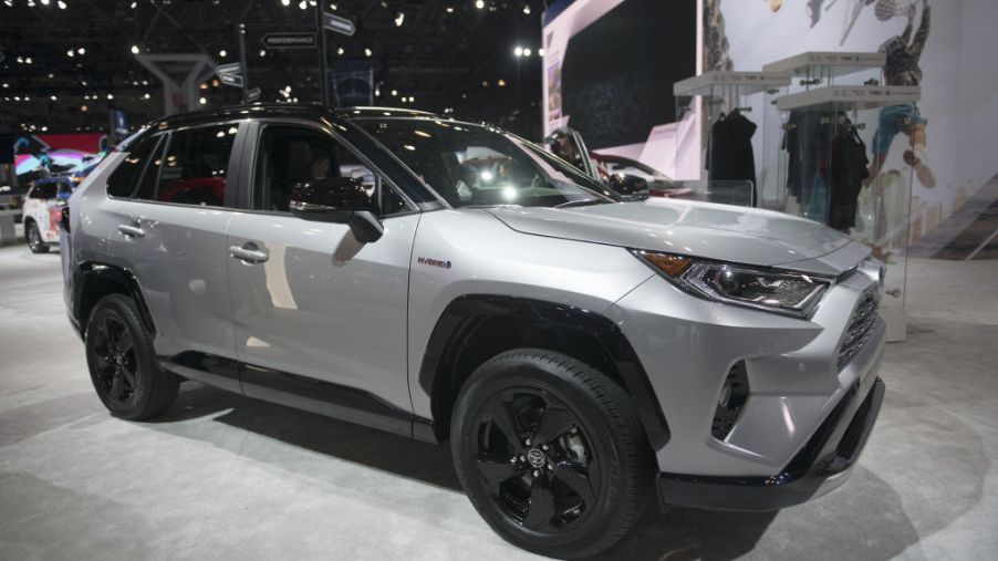 A silver Toyota RAV4 on display at an auto show.