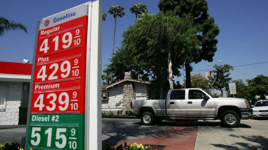 A pickup truck at a gas station about to fuel up.