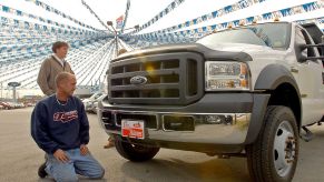 Sales associate shows a F-550 Ford truck to a potential buyer