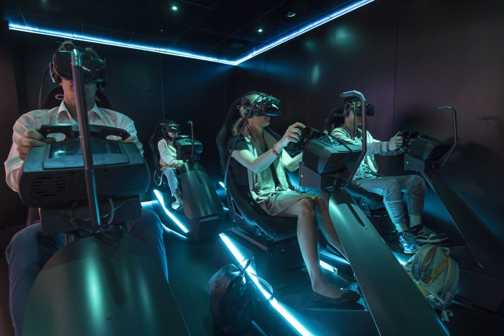 Attendees play a virtual reality racing game at the Auto Shanghai 2019 show