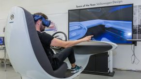 A user experience designer wears a virtual reality headset at the Volkswagen headquarters