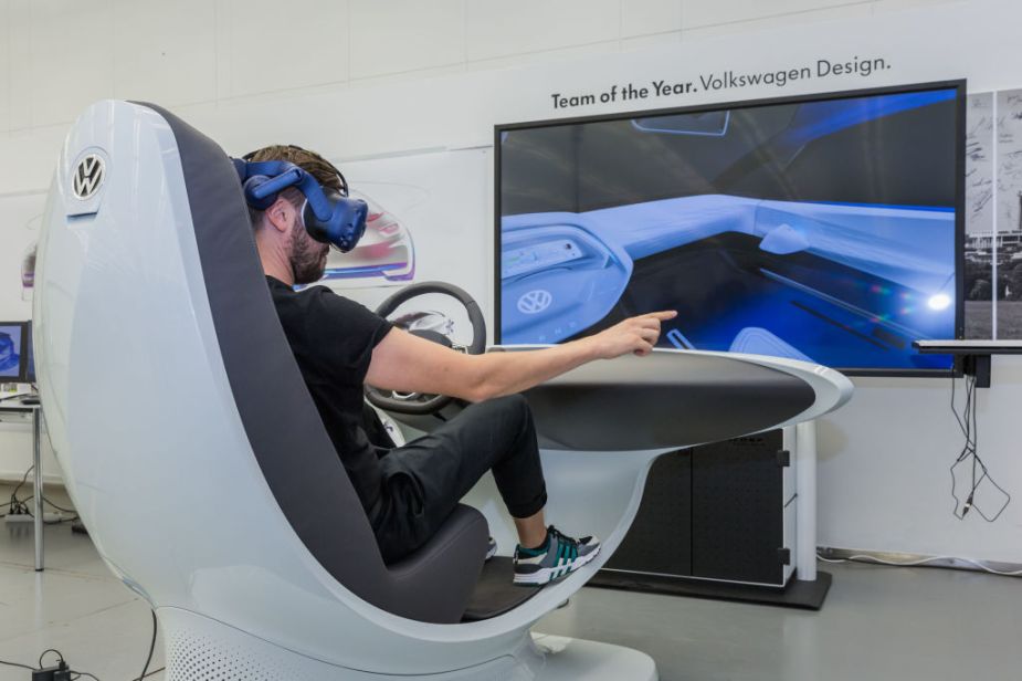 A user experience designer wears a virtual reality headset at the Volkswagen headquarters