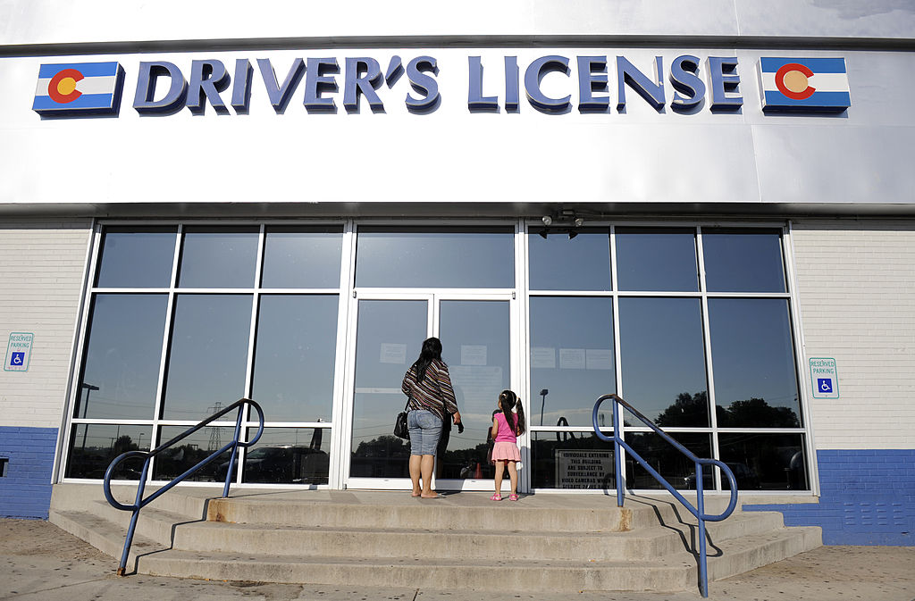 Woman and daughter enter the Denver DMV to get a driver's license