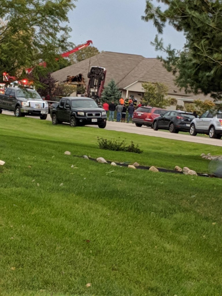 First responders extracting Ram 1500 from roof