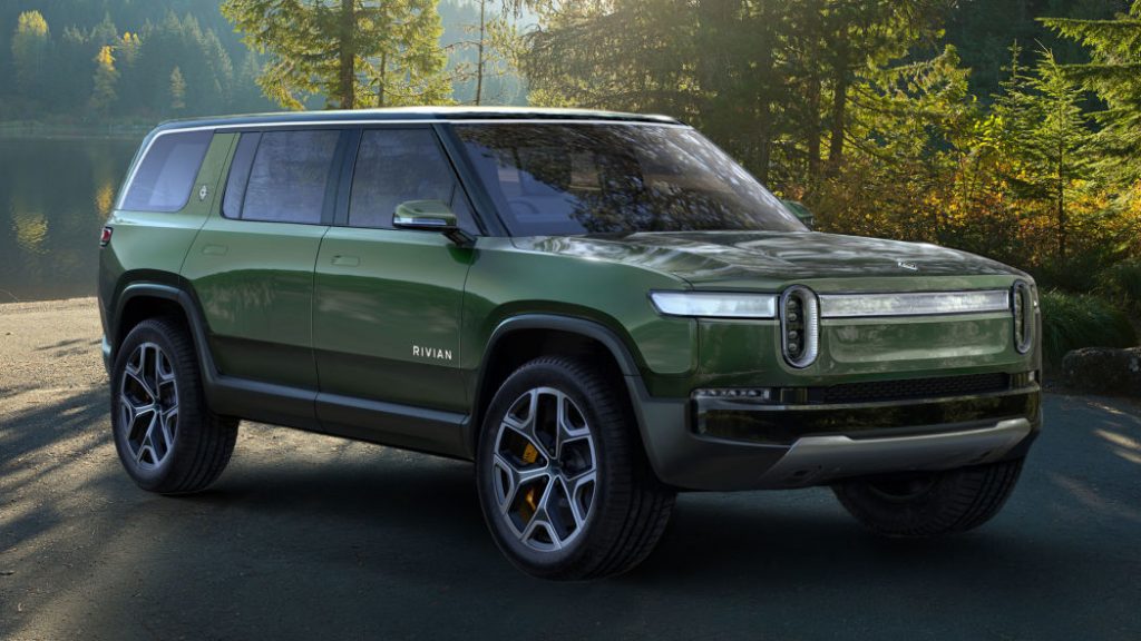 Rivian R1S in launch green parked near some trees