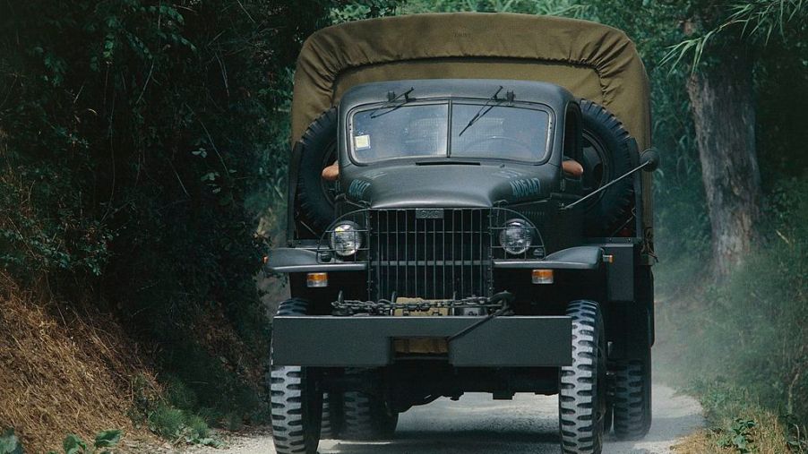 U.S. military vehicles, a 1942 GMC, drives down the road