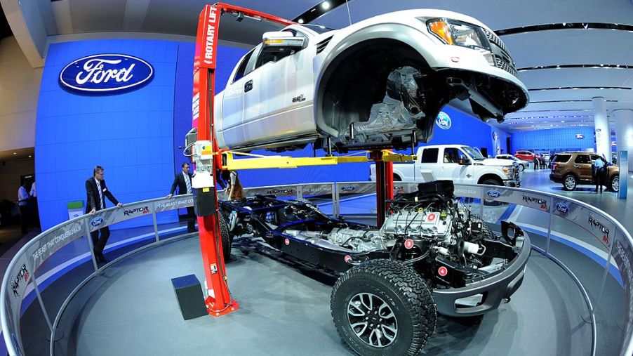 The body of a 2002 Ford F-150 Raptor truck is lifted off its chassis