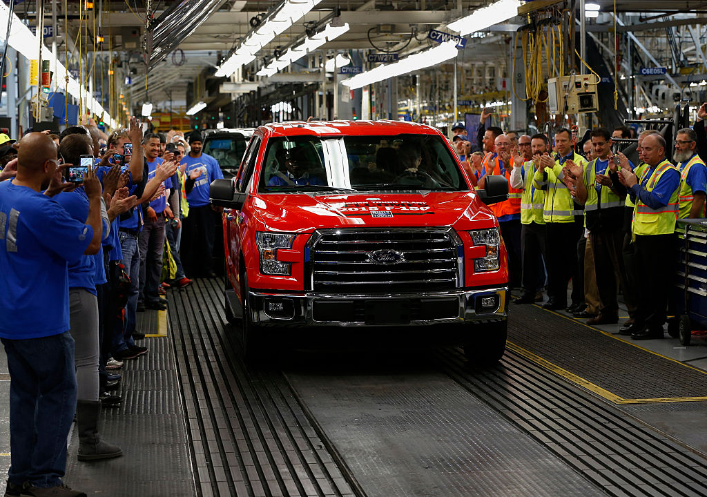Employees cheer as the first 2015 Ford F-150 truck rolls off the production line in 2015