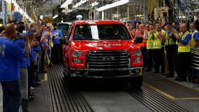 Employees cheer as the first 2015 Ford F-150 truck rolls off the production line in 2015