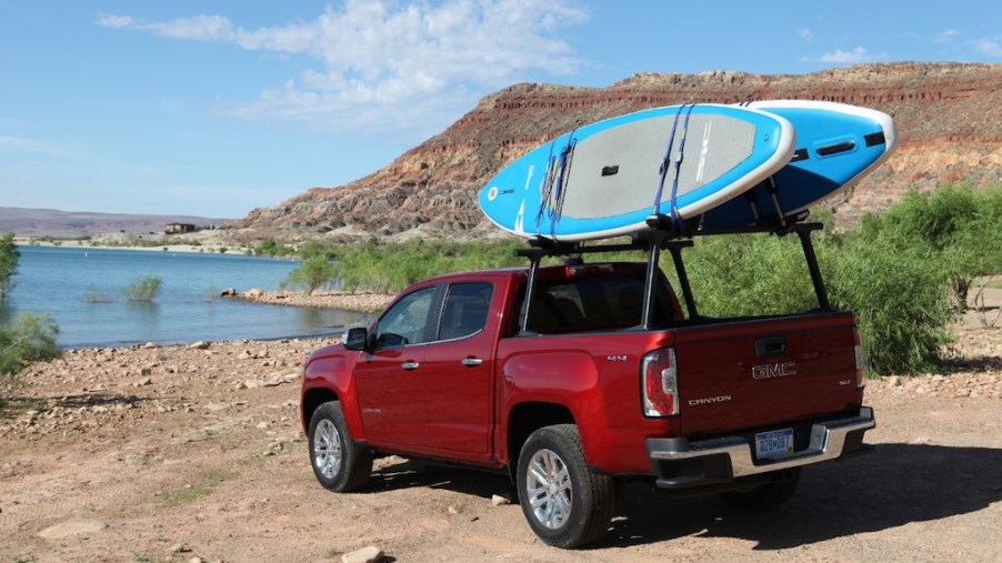 The 2020 GMC Canyon transports a stand-up paddleboard