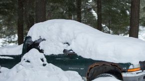 A Dodge Dakota is covered in snow