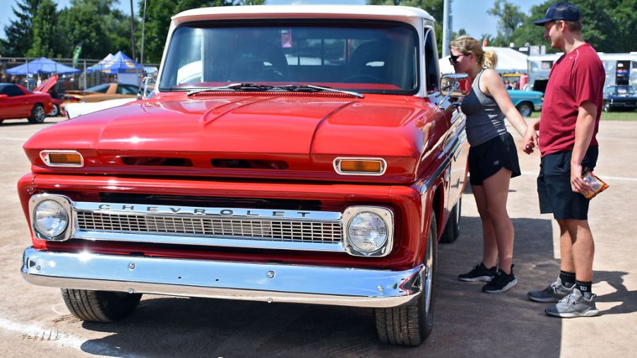 Event attendees check out a vintage Chevrolet pickup truck