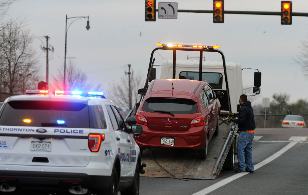 A red Mitsubishi is towed in Denve