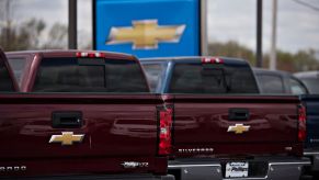 Chevy Silverado pickup trucks displayed for sale at a dealership.