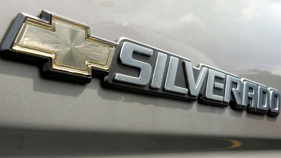 A Chevy Silverado logo displayed on the back of a truck.