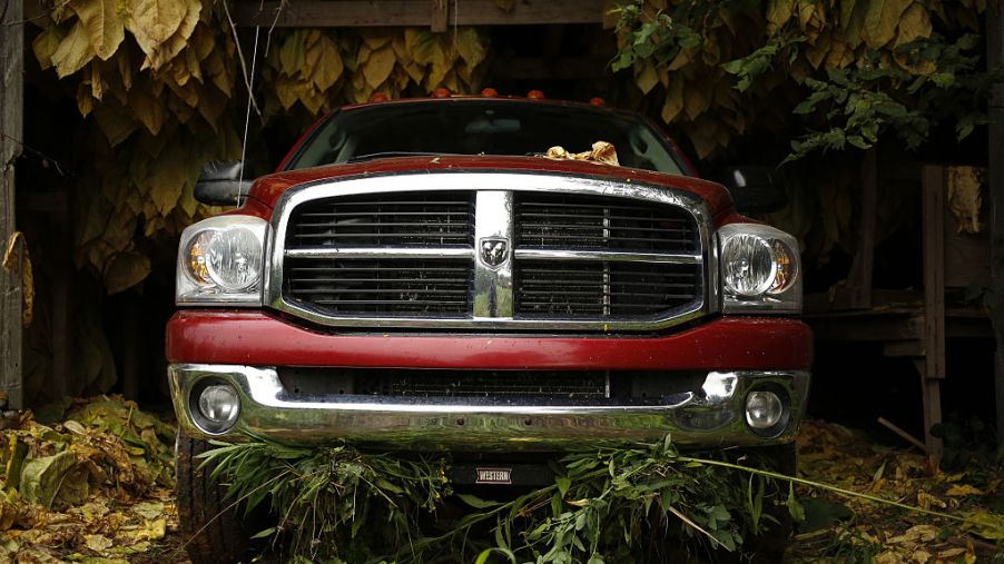 A Dodge Ram pickup truck sits parked inside a barn