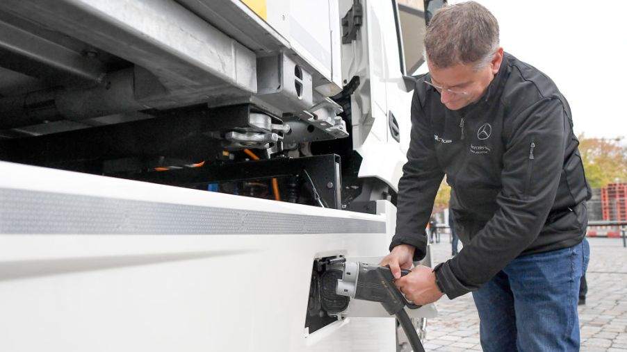 A man demonstrates how the batteries of the electric truck