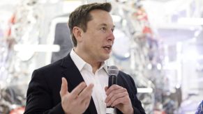 Tesla CEO, Elon Musk, talking into a microphone.