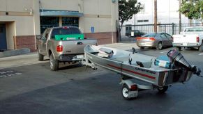 A Ford F-150 towing a small boat.
