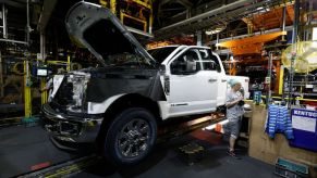 A worker builds a Ford F-250 as it goes through the assembly line at the Ford Kentucky Truck Plant