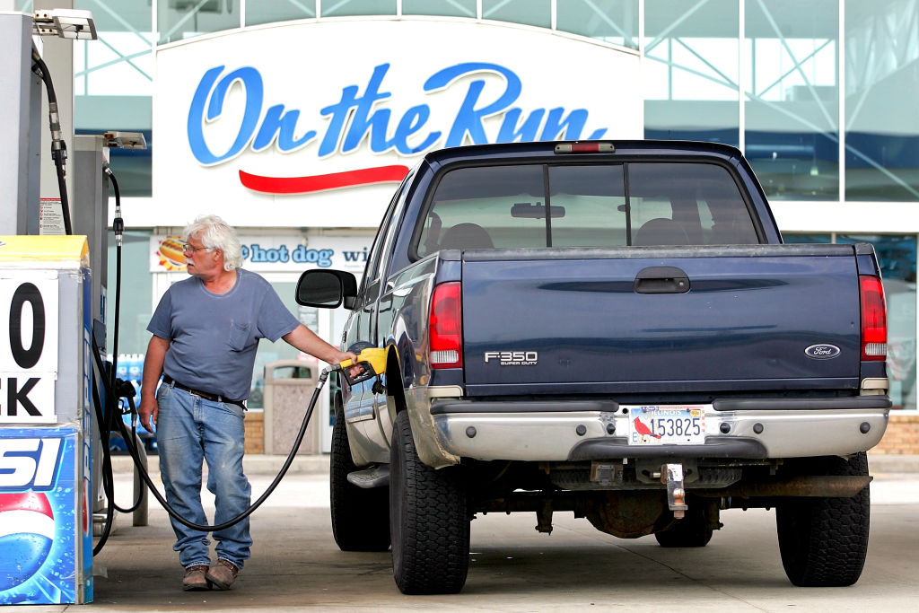 A Ford F-350 heavy-duty truck at a gas station.