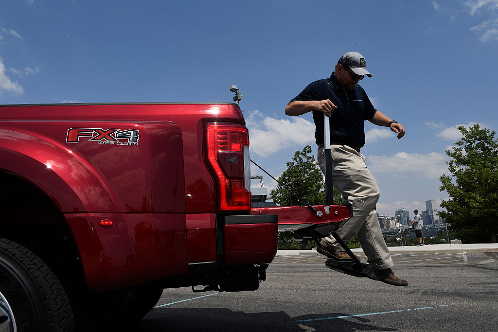 Man jumps off the tailgate of a Ford F-Series Super Duty truck