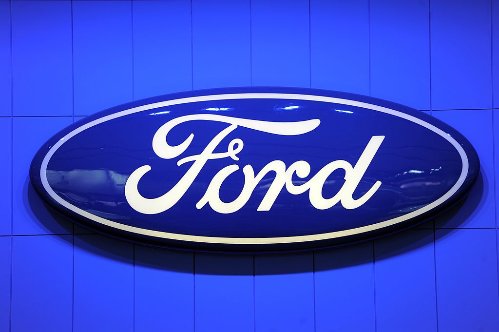 A Ford logo displayed at an auto show.